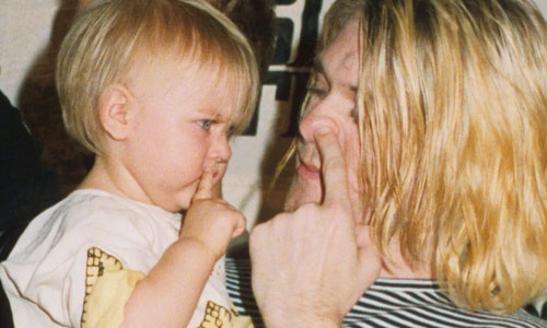 Kurt Cobain playing with his daughter Francis Bean Cobain