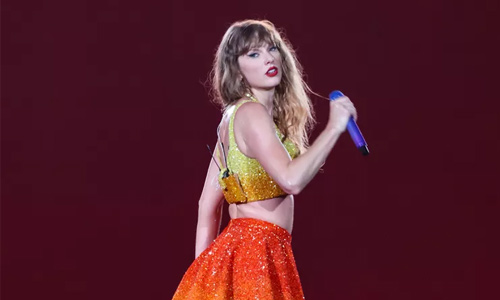 Taylor Swift reps the red and gold in Paris